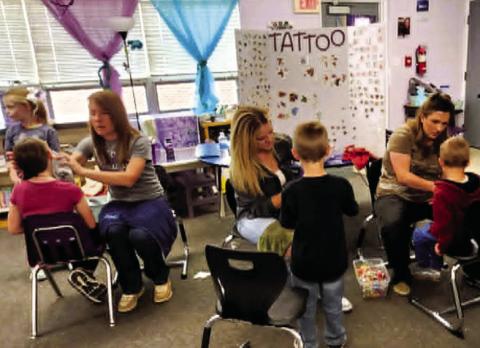 The temporary tattoo booth was a popular hit at the Rye Elementary Spring Carnival. Photo by Shirley Pigg