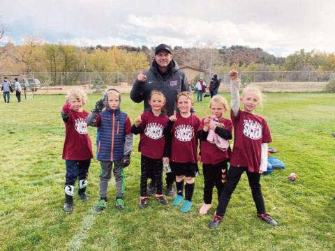 John Crowell with the eight-year-old soccer team he coached in Colorado City last fall.