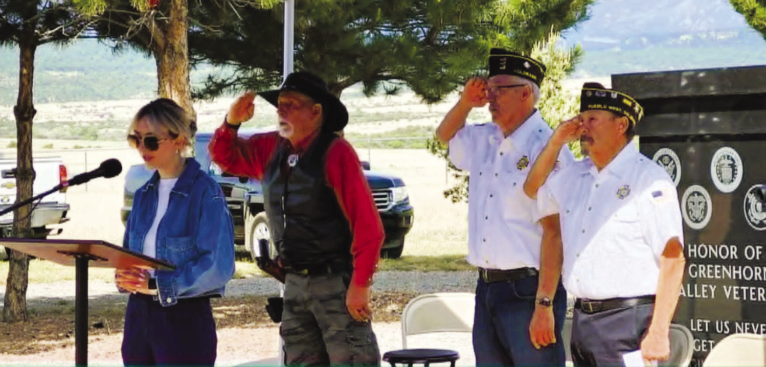 Rory M. Lewis did a beautiful job with moving, patriotic songs for the 2026 Memorial Day Ceremony. Standing behind her (l-r) are Vietnam veterans Donald Shumake, Jerry Collins, and Herman Arellano. Photo by Shirley Pigg