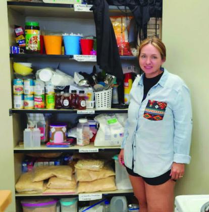 Kari Purvis shows some of the donations the Craver Middle School Home Ec department has received from the community. Photo by Shirley Pigg