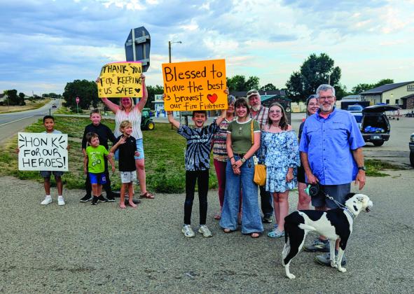 A group from Colorado City were exuberant in waving the banners and yelling 'thank you' as the firefighting crew changed shifts. Photo Courtesy of Deb Straub