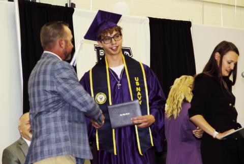 2023 Rye High School Graduate Elijah Perez Jr is congratulated by Pueblo Public School District Board of Director John Christianson. Perez has made a committment to the United States Navy, and will report for duty in one month. Photo by Terry Kraus