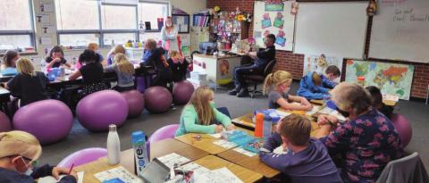 Rye Fire Protection District Firefighter and Public Education Officer, Matt Kell, reads to children at Rye Elementary School. Courtesy Photo