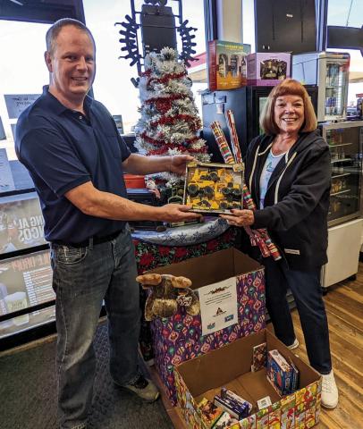 Fast Break Manager Jon Hendry and Colorado City/Rye Lions Club Treasurer Donna Walker-Hulben team up to collect toys for area children again this Christmas season. Photo by Deb Straub