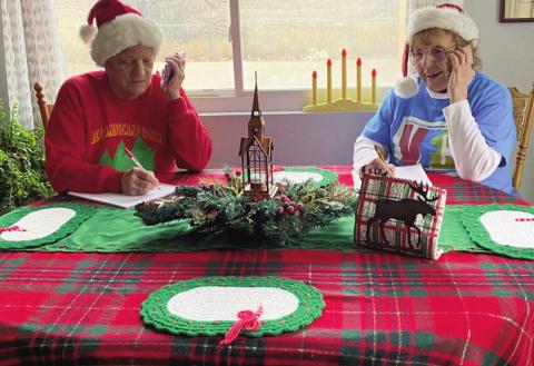 VFC elves double checking the names of children on their Santa list! Courtesy Photo