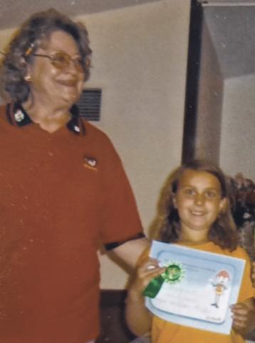 Seven-years-old Christie receiving an award for completing a first year in Awana with Sparks leader Barb Zorc. Courtesy Photo