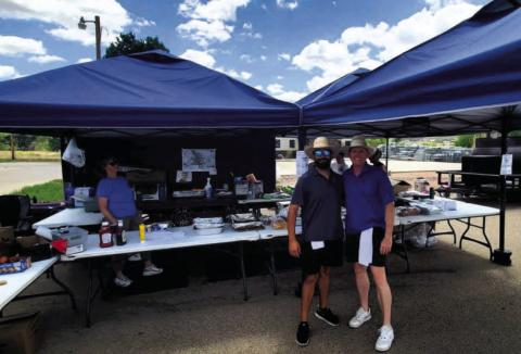 Tyson Rodriguez (L) and Chris Dorris of Insurance Busters.net step away from the grills for a moment to pose for a picture. Photo by Shirley Pigg