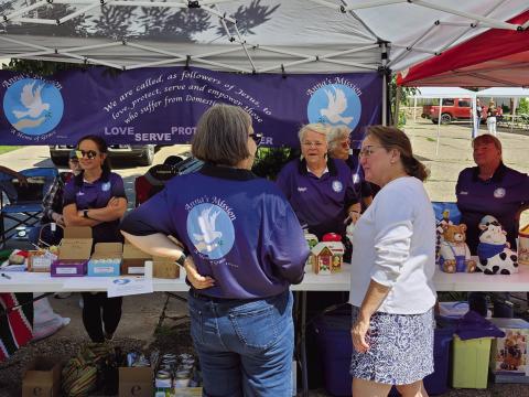 Volunteers for Anna's Mission explained their work to fairgoers at their booth during the Rye Town Square Fair. Photo by Shirley Pigg