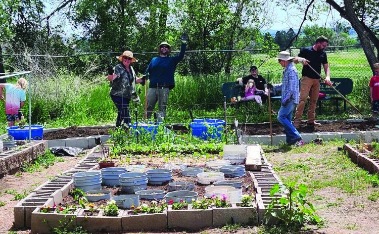 Community garden participants enjoy working together in a previous year's garden. Photo by Shirley Pigg