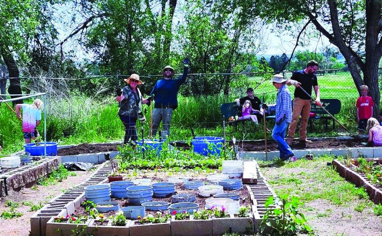 This hard-working group of volunteers built two new beds in the Community Garden on Saturday, June 1. Photo by Shirley Pigg