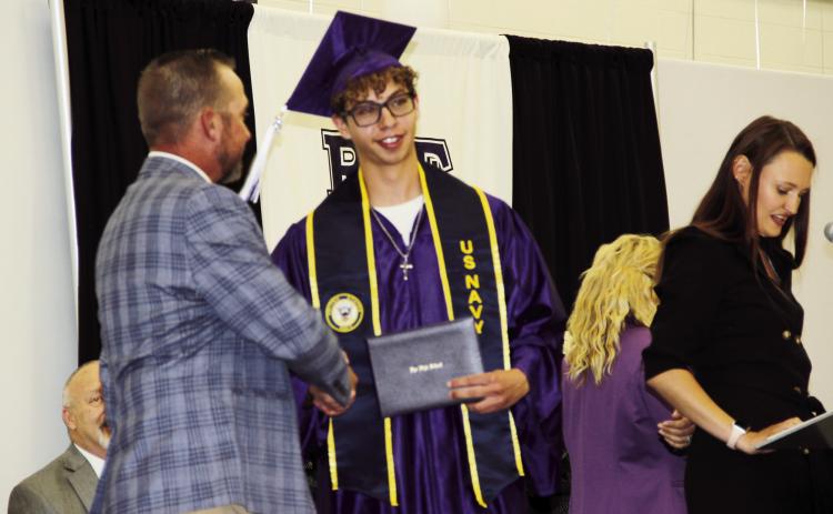 2023 Rye High School Graduate Elijah Perez Jr is congratulated by Pueblo Public School District Board of Director John Christianson. Perez has made a committment to the United States Navy, and will report for duty in one month. Photo by Terry Kraus