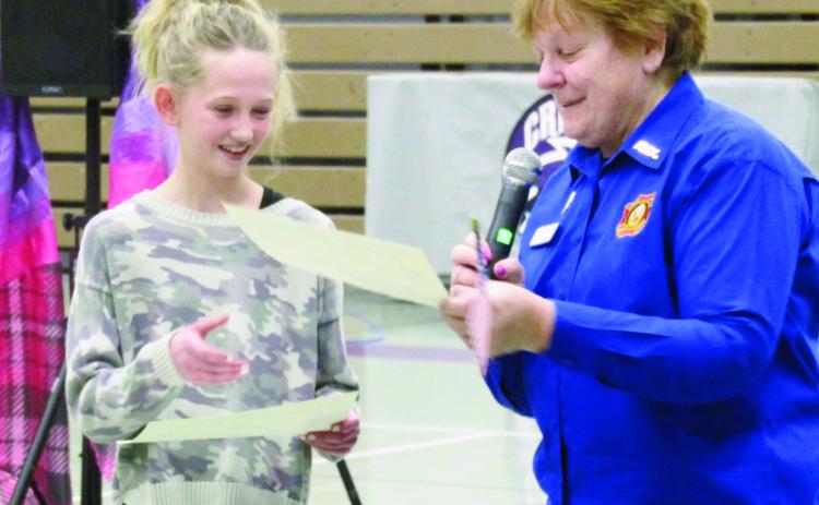 Toni Leibnow, VFW Post #7305 (R), presents Patriot’s Pen award to Molly Balenseifen at the Craver Middle School ceremony. Photo by Shirley Pigg