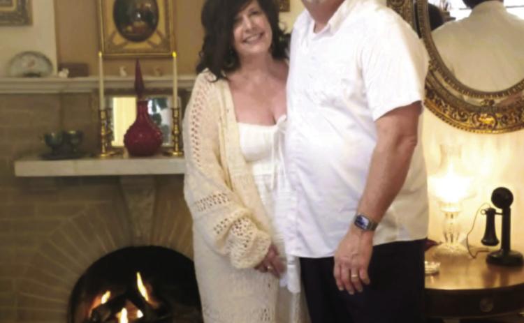 Cindy and Jeff Bailey, along with the official Abriendo Inn greeter, Bentley, pose in the lobby of the Abriendo Inn during the winter of 2026 Photo by Shirley Pigg