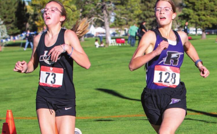 Photo by Sue Barcus Rye’s Mylee Garner finishing neck and neck with the Colts runner over the finish line at the Pueblo City/County 2021 Cross Country Championships on Wed., Oct 13. Garner finished in 25:52.20.