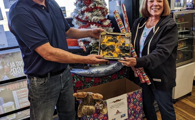 Fast Break Manager Jon Hendry and Colorado City/Rye Lions Club Treasurer Donna Walker-Hulben team up to collect toys for area children again this Christmas season. Photo by Deb Straub