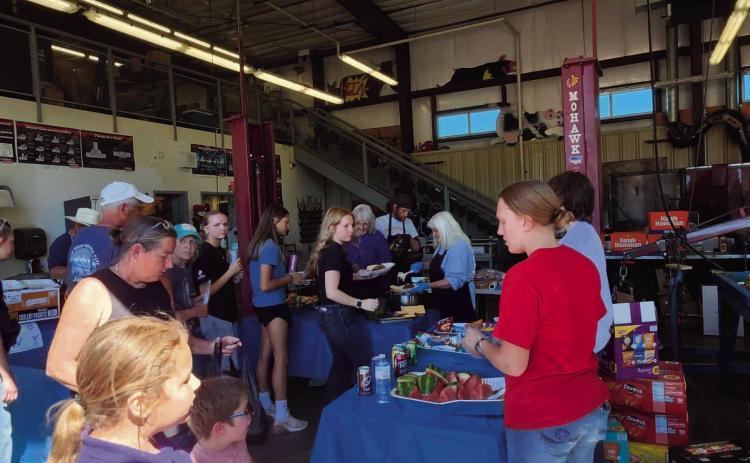 The famous FFA BBQ was a busy place as FFA members and volunteers served meals. Photo by Shirley Pigg