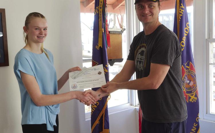 Matt Akers hands Molly Chandler a check and certificate for her 2nd place winning essay in the Voice of Democracy Contest sponsored by the local LTC Fred A. Ettleman Veterans of Foreign Wars Post #7305. Photo by Shirley Pigg