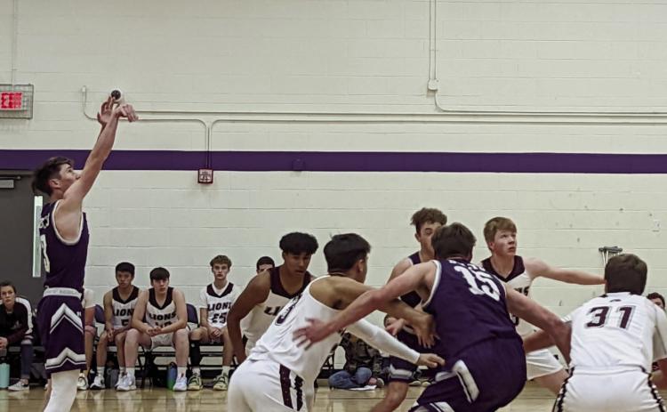 Jay Graham, #3, makes free throw shots. Graham and his teammates won their initial two games of the season. Photo by Deb Straub