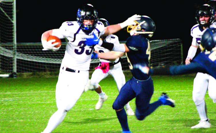 Dylan Hurne delivers a stiff-arm. Photo Courtesy of Marla Crowell
