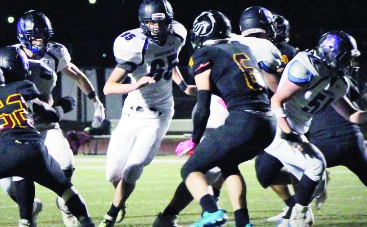 Jared Betz #65 leads a Thunderbolt ball carrier through a hole on the right side of the line during the victory over Banning Lewis. Photo by Karen Rochester