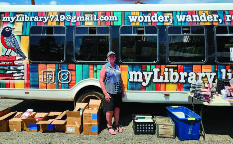 Robin Smith was all smiles as she displayed the myLibrary bookmobile at the Rye Town Square Fair. Photo by Shirley Pigg