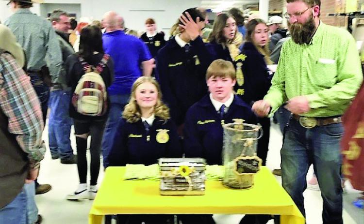 Rye High School Future Farmers of America Advisor Ethan Beeman (R) shares a moment with FFA members while taking tickets for the 7th Annual Rocky Mountain Oyster Fry and Auction. Photo by Shirley Pigg
