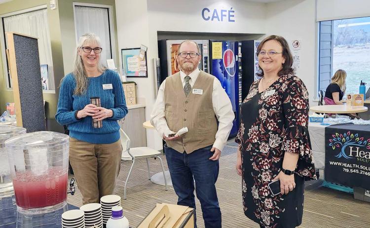 Linda Lewis, Branch Manager of the Greenhorn Valley Library, with Kieran Hixon and Tish Franklish (L-R) from the Pueblo City-County Library greet guests to discuss the new Telehealth Program. Photo by Shirley Pigg