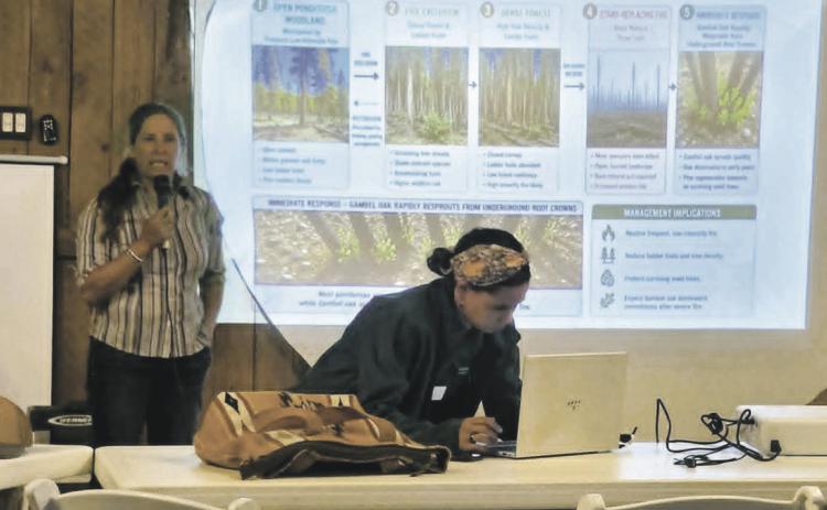 Annie Overlin (L) and Beth Hayes (front) explain how Colorado State University Extension Office can help Ag Producers who suffered losses in the Aspen Acres Fire. Photo by Shirley Pigg