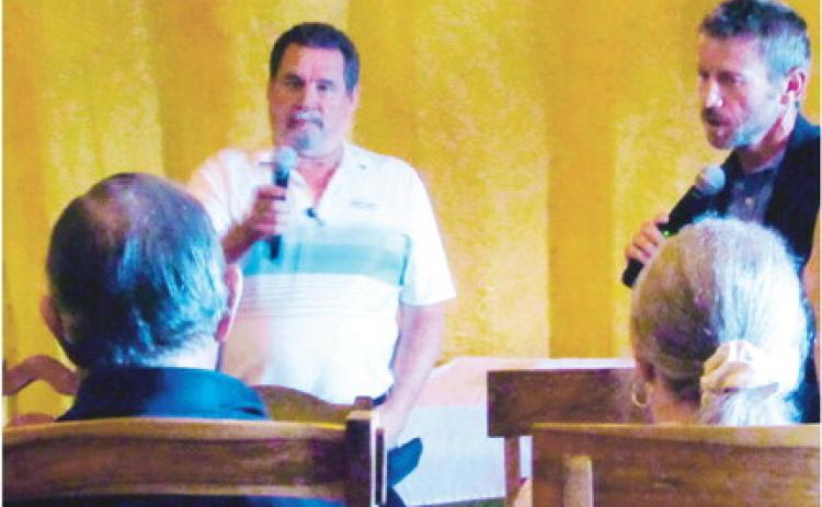 Jim Eccher (L), Colorado City District Manager, and Zach Swearingen, Pueblo County Commissioner, listen intently to a resident's concerns at the Town Hall Meeting held on September 14, at the Three Sisters Tavern and Grill. Photo by Shirley Pigg