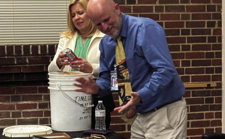 D70 Superintendent Ronda Rein and Assistant Superintendent Bob DiPietro removing items from the time capsule. Courtesy Photo