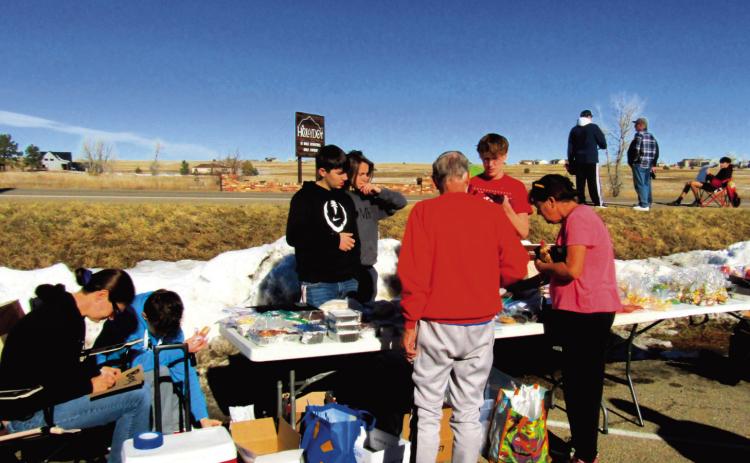 The soccer team boys, coaches, and parents hosted a huge fundraising bake sale at Ace Hardware in December. Photo by Shirley Pigg