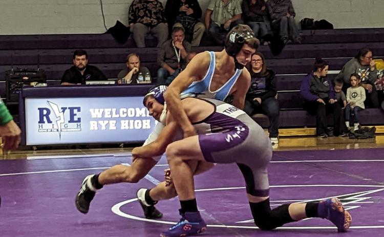 Rye High School wrestler Cody Dodge makes a move on his Trinidad opponent. Photo by Deb Straub