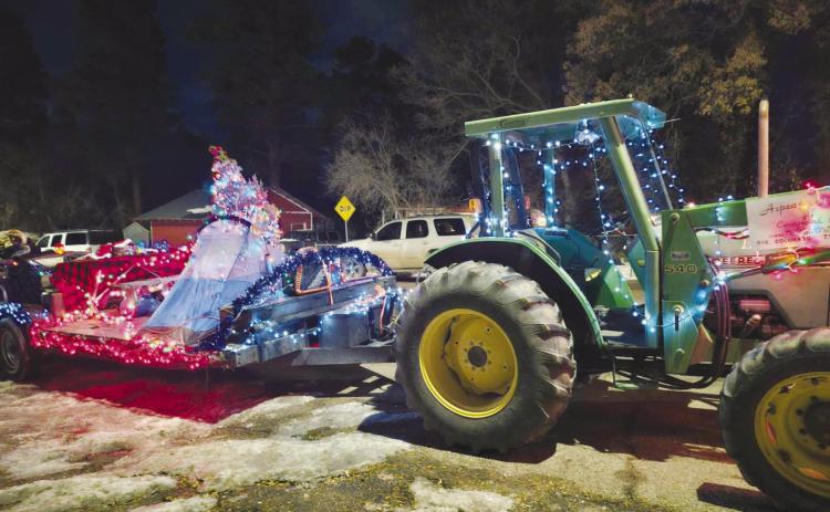 Aspen Acres Campground won First Place in the Greenhorn Valley Parade of Lights with their festive float and green John Deere Tractor. See article on p. 5. Photo by Shirley Pigg