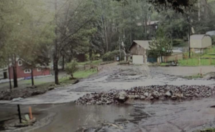 Despite area residents' best efforts, flood waters continue to overwhelm barriers. Photo by Shirley Pigg