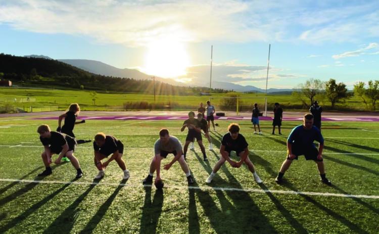 RHS Head Football Coach Connor Pigg (far right, top) observes early-season football practice. Courtesy Photo