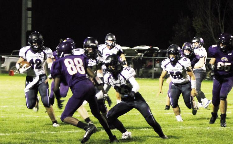 Samuel Adams #12 turns the corner around right end. Rye gained over 200 yards on the ground Friday. Photo by Karen Rochester
