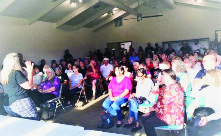 Sara Blackhurst, Action 22, speaks to a capacity crowd about securing a permanent solution to the Colorado City postal issues. Photo by Shirley Pigg