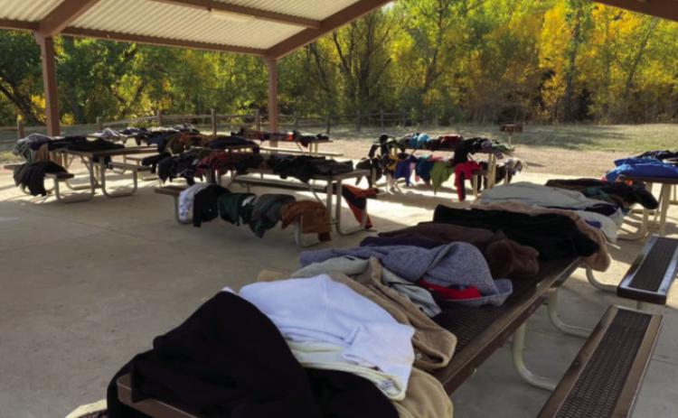 Jeremy Walker displays donated coats at the Pavilion in Green-With horn Meadows Park the Sunday following the Lions Car Show. Courtesy Photo