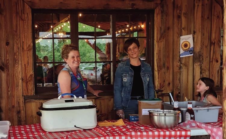 Volunteers cheerfully served a mouth-watering smoked brisket dinner at the Faith Circle's Mountain Aire Festival Photo by Shirley Pigg