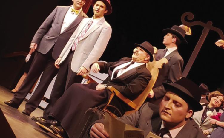 George Bailey in front played by Oliver Carlon and Henry Potter played by Jeffery Orman, as well as other town members in Bedford Falls Courtesy Photo