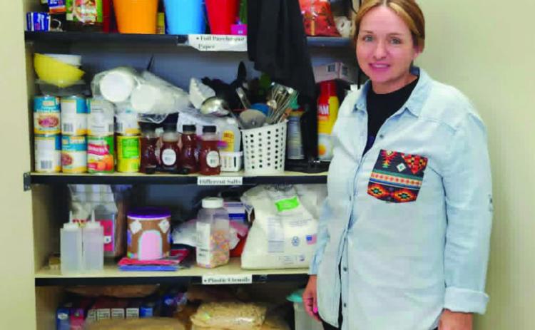 Kari Purvis shows some of the donations the Craver Middle School Home Ec department has received from the community. Photo by Shirley Pigg