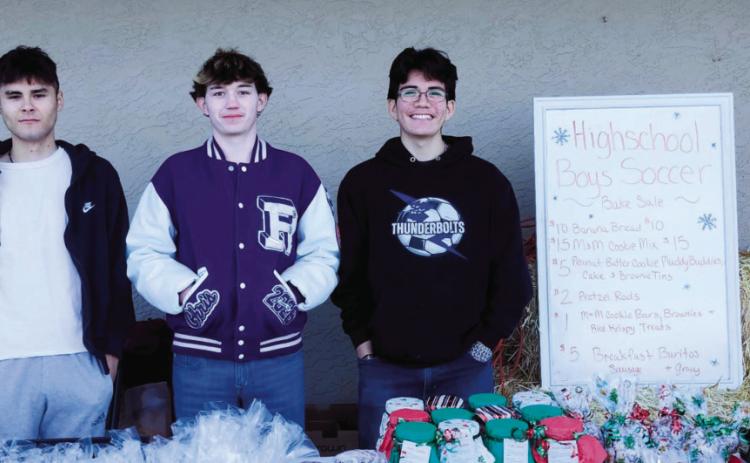 Wesley Mascarenas, Chris Scott, and Nate Cole held a bake sale at Ace Hardware to raise money for uniforms and travel costs to play soccer. Photo by Shirley Pigg