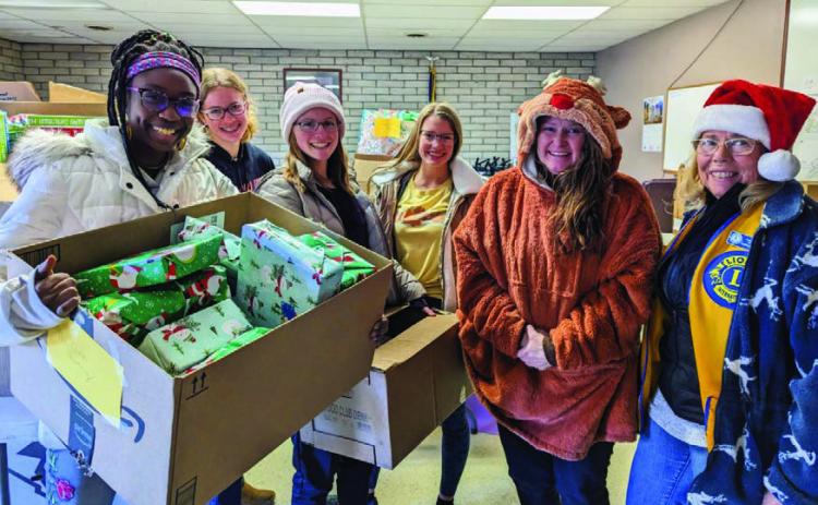 Lions Club Leos (L-R) Haley Bowler, Clara Chandler, Audry Bowler, Mylee Garner, Recipient Shawna McGinn and Lion Fran Holliday celebrate the season of giving and thank area residents who generously donated to the annual toy and food drive. Photo by Deb Straub