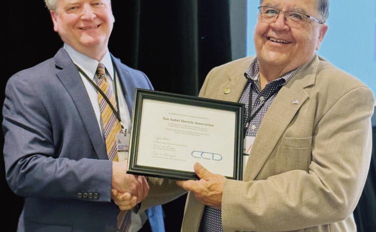 Board President Edward “Ray” Garcia accepts an award at CREA’s Annual Meeting last week. Kent Singer, Executive Director of CREA, recognized San Isabel Electric’s Board for every board member earning Credentialed Cooperative Director Certification. SIEA’s board was the only recipient in Colorado of this award. Courtesy Photo