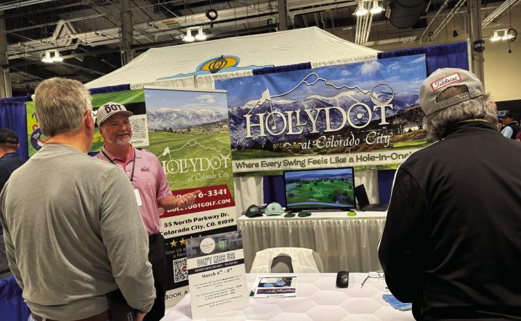 Mike Reilly (center), at the Colorado Golf Expo, acquainting golfers with the Hollydot Golf Course. Reilly started his annual trek to the event four years ago and has watched interest in Hollydot grow. Courtesy Photo