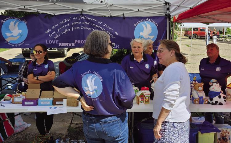 Volunteers for Anna's Mission explained their work to fairgoers at their booth during the Rye Town Square Fair. Photo by Shirley Pigg