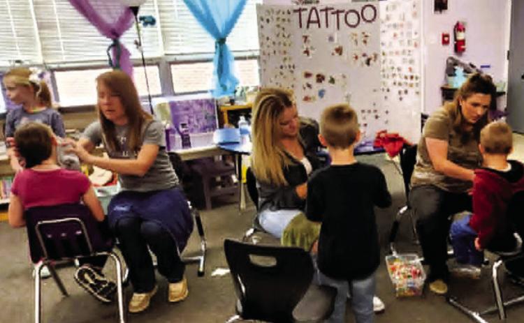 The temporary tattoo booth was a popular hit at the Rye Elementary Spring Carnival. Photo by Shirley Pigg