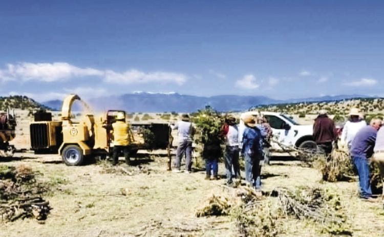 Many Hatchet Ranch homeowners and FireWise volunteers turned out on Friday, May 8, to help chip the slash piles that they have cleared away from their homes.