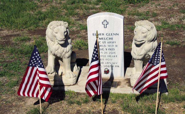 The Elmer Glenn Melchi gravesite displays three American flags, indicating three active duty, family members who served in the United States Armed Forces. Photo by Terry Kraus