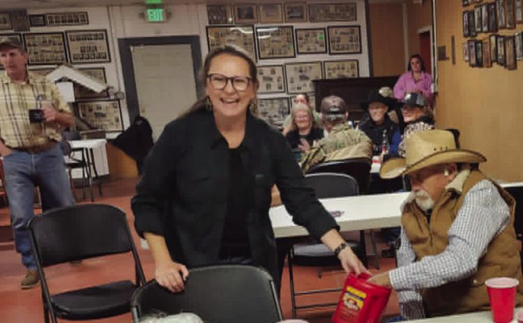 PCSA Secretary Jana Snell, as Ron Kroll draws for the winning raffle ticket. Photo by Shirley Pigg